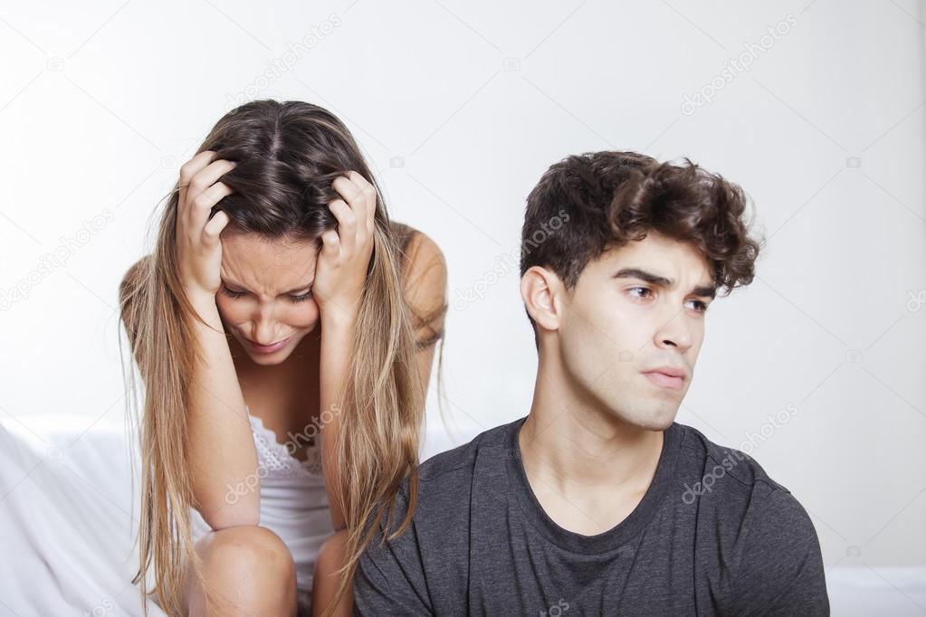 Upset couple mad at each other in their living room